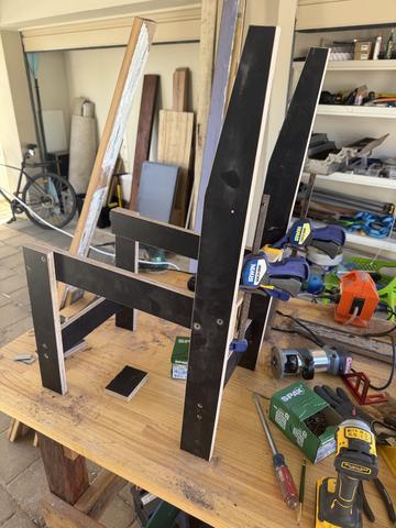 Scrap ply side frames standing on the bench.