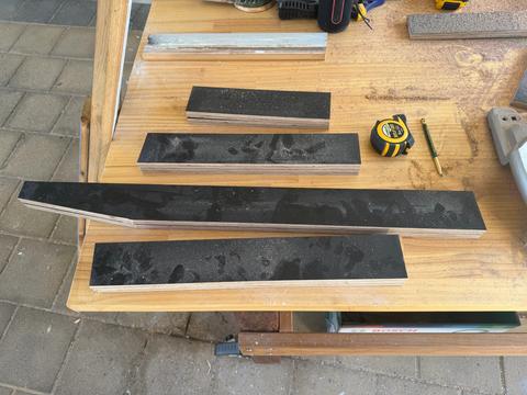 Parts for the scrap-ply chair, cut from salvage black film faced form ply.