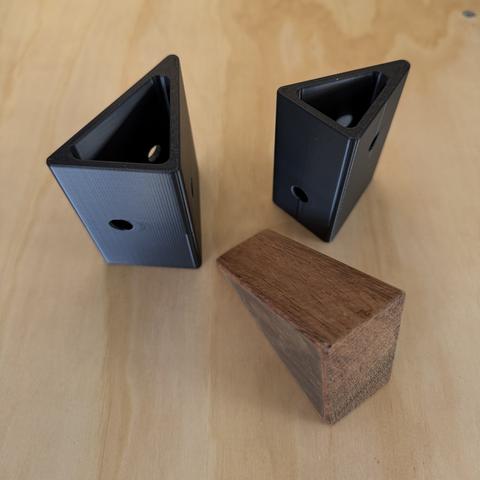 Printed corner sockets beside the sawn block they replace.