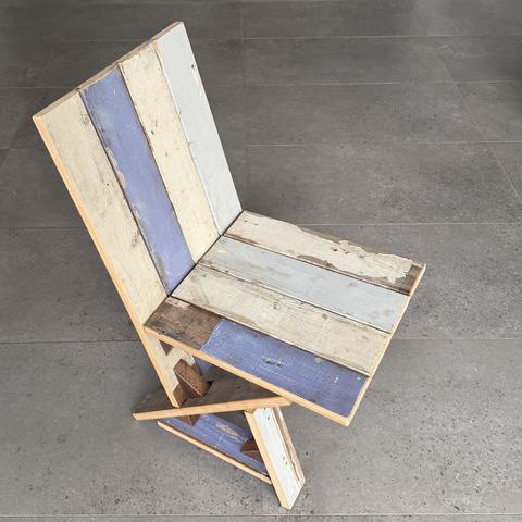The scrap chair: salvage boards, old paint, new geometry.