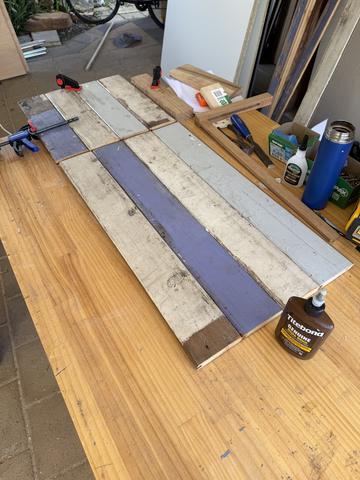 Painted salvage boards become a panel: the cheapest stock yet.