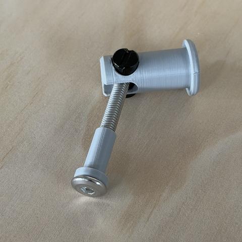 The printed barrel nut holder with its bolt: easy to install, but PETG is not strong enough to be in the preload path. This is a "looks like" prototype.