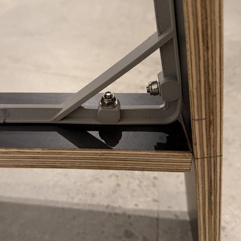 Triangle detail: two bolts and nyloc nuts per corner.