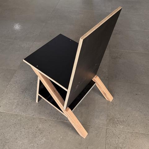 Rear three-quarter view of the keel chair showing back panel, seat and both keels