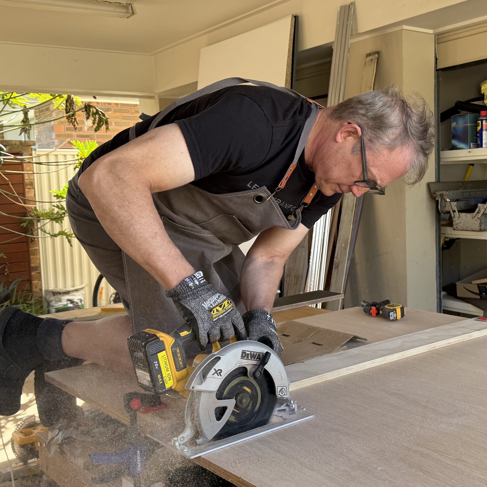 Half of the centaur, at work: cutting salvage ply on the bench, 20 August 2026. The other half is not in the picture, which is accurate.