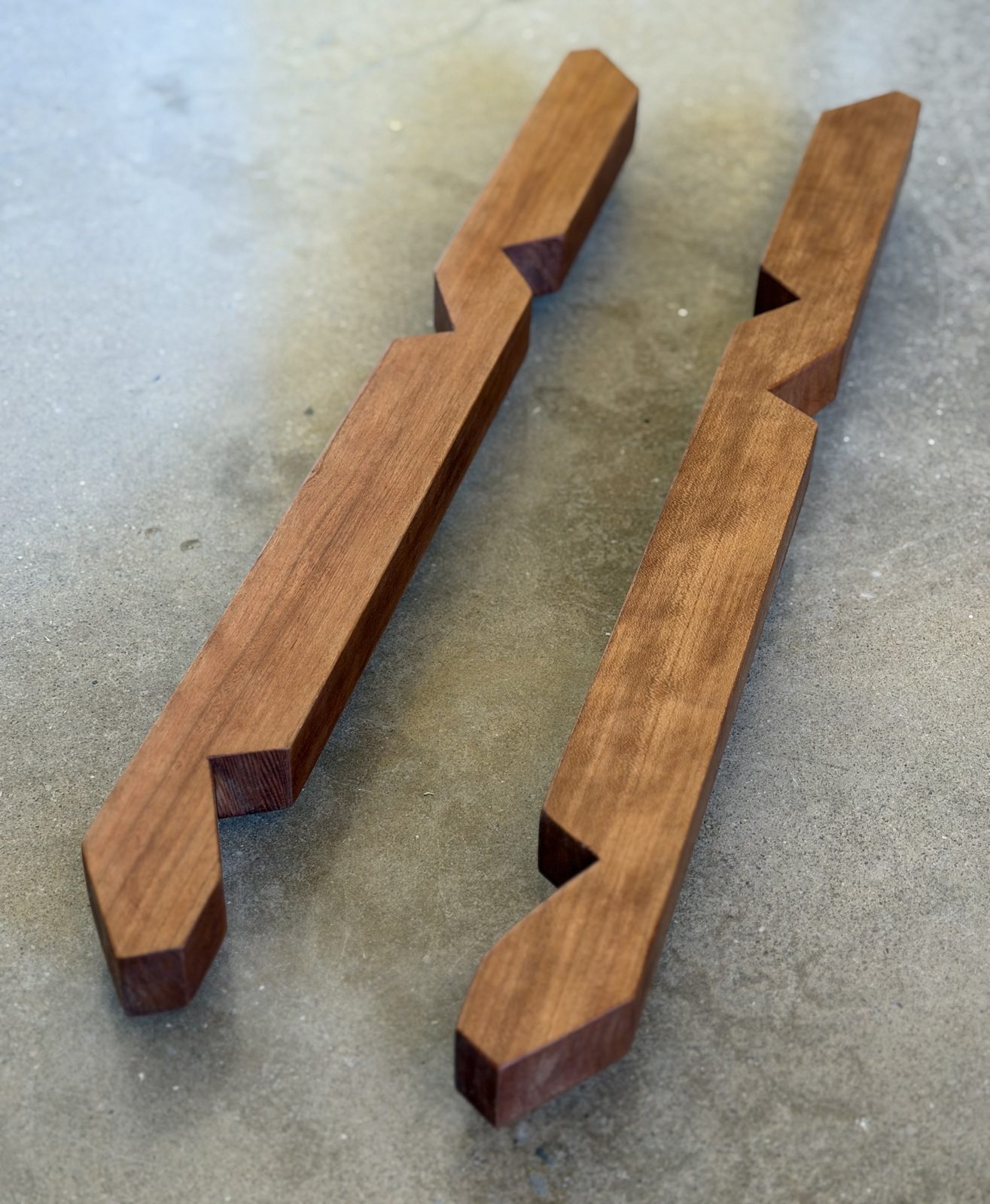 Two cherry keels lying side by side, each with three fish-mouth notches