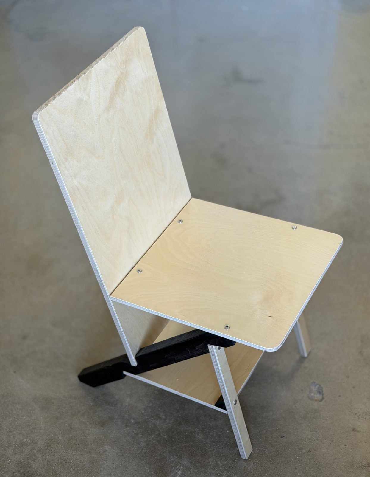 A Keel Panel chair from the front quarter, plywood panels and a dark keel