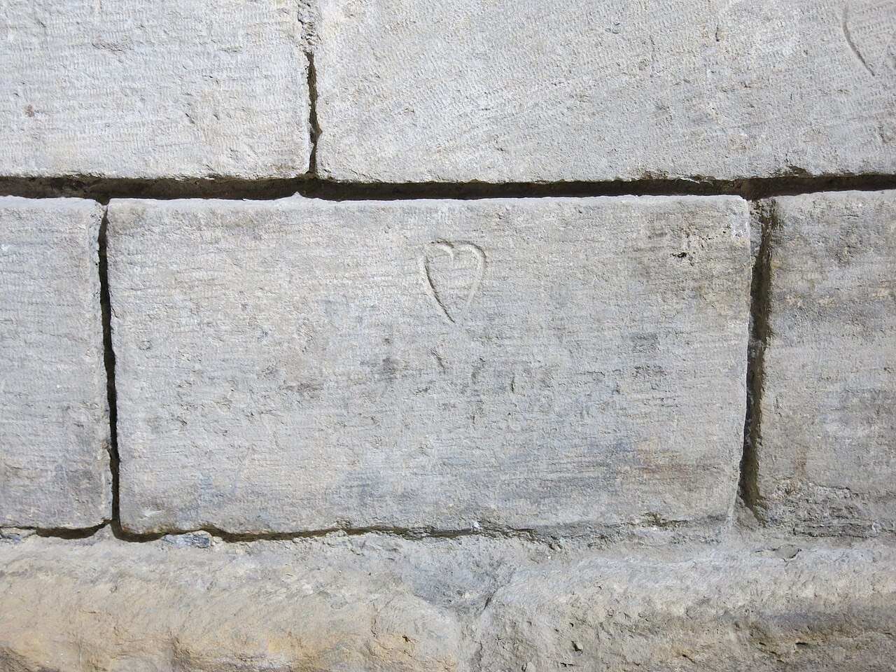 An incised stonecutter's mark on medieval stone, a tower of the old Louvre.